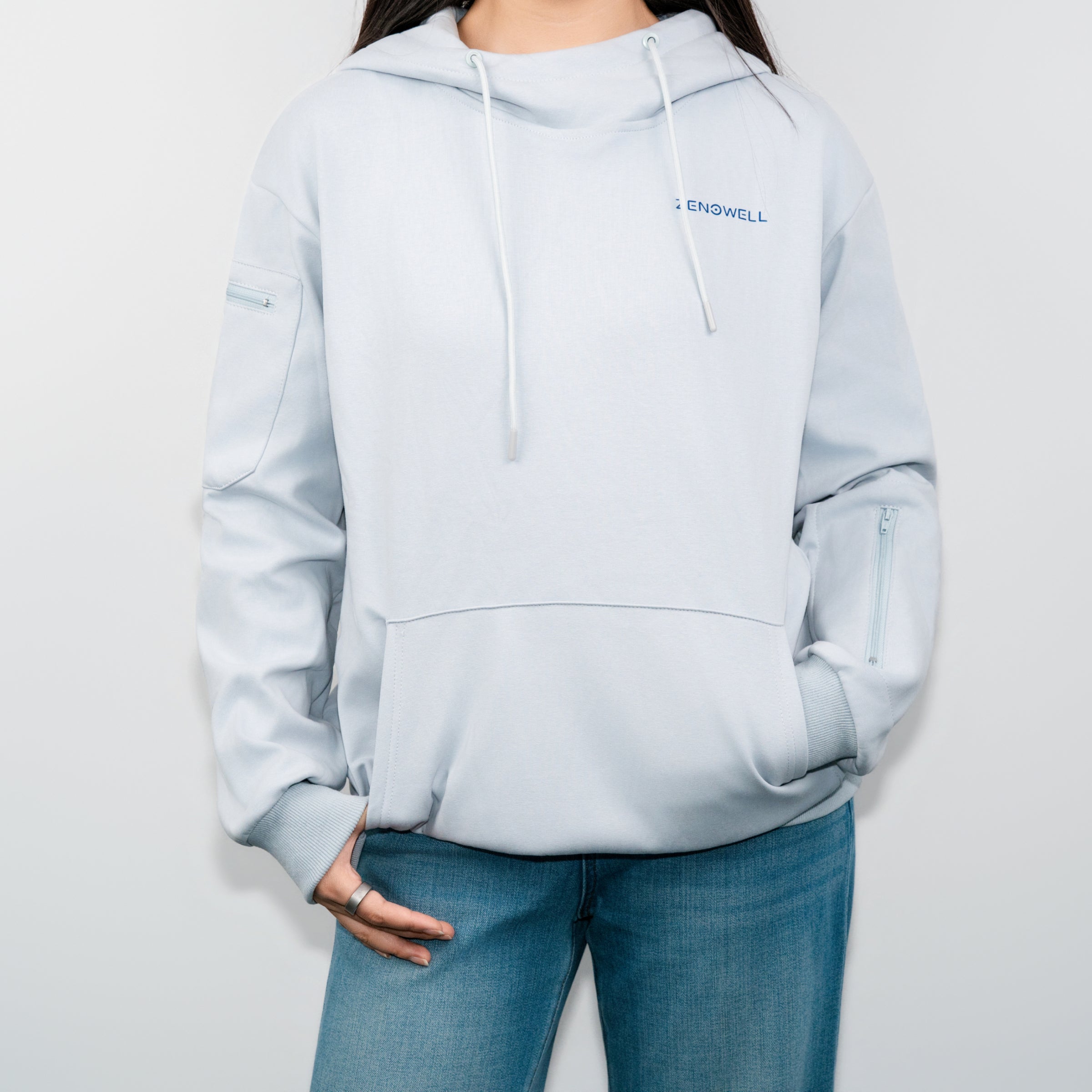 Front view of a person wearing a light blue ZenoWell hoodie